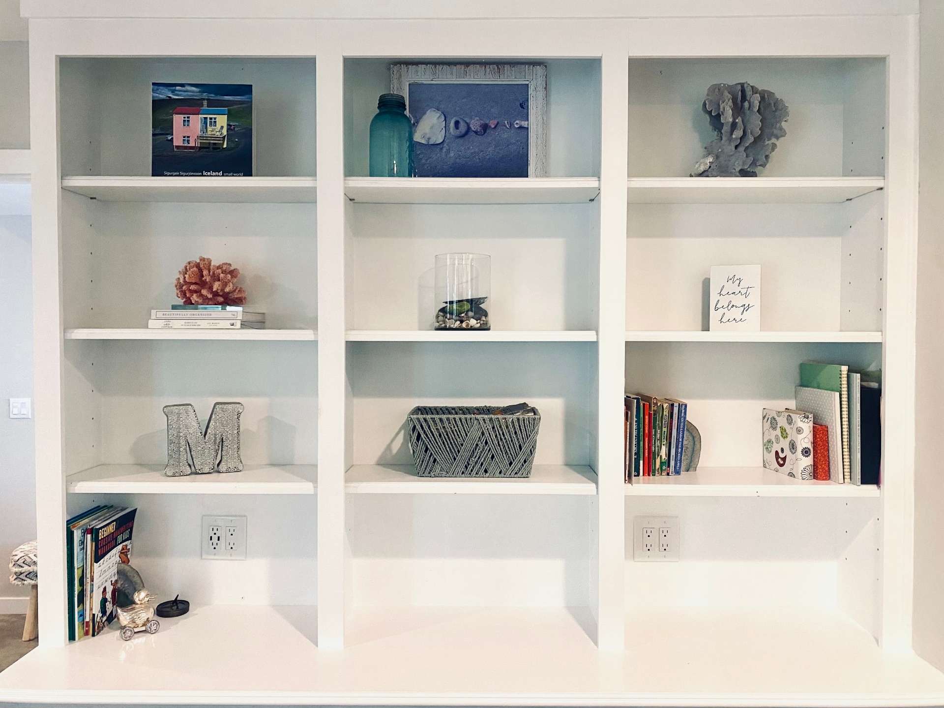 Floor-to-ceiling custom built-in bookshelves in a warm greige living room